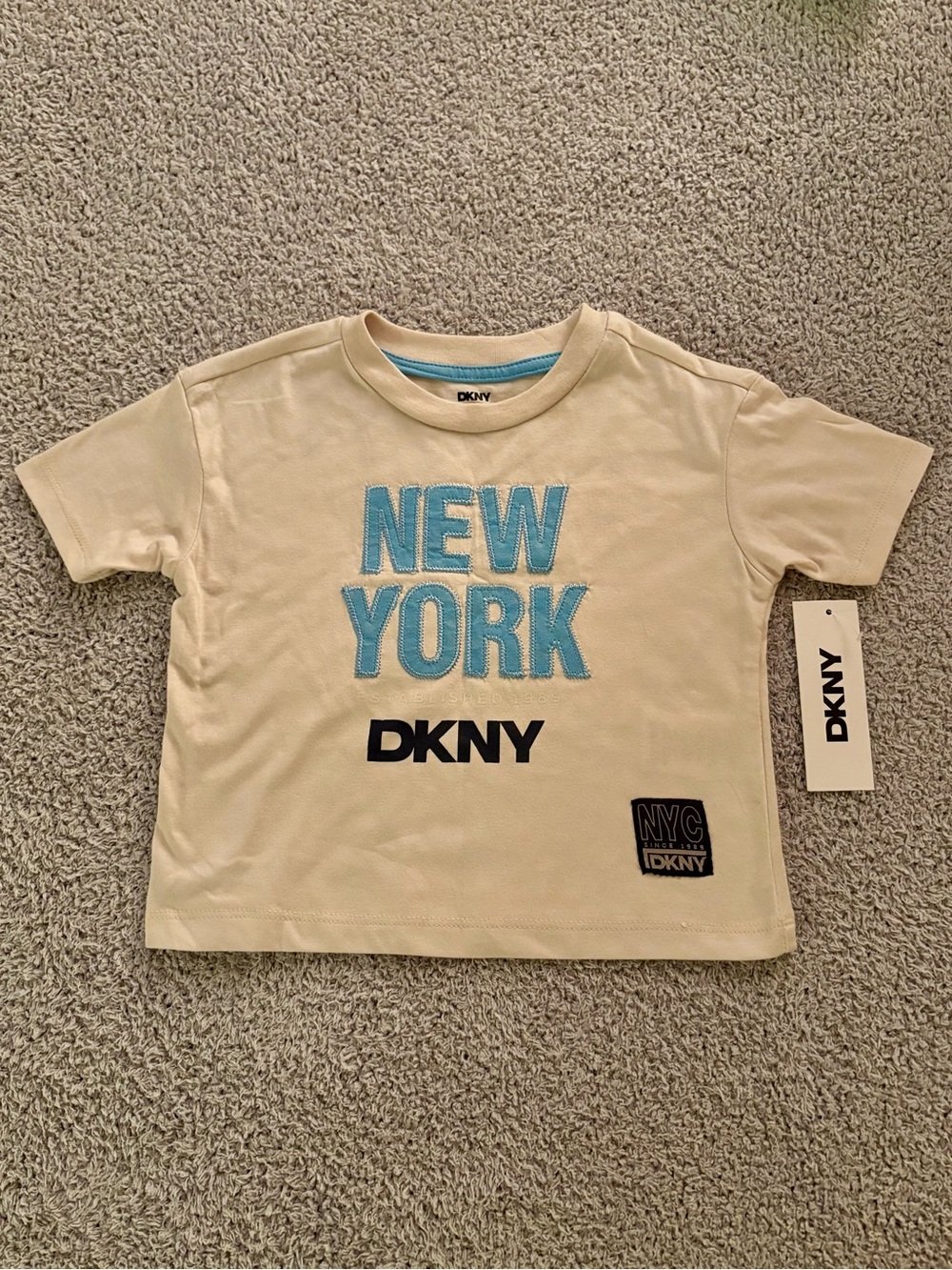 DKNY Cream Short Sleeve Tee with Blue "NEW YORK" Appliqué